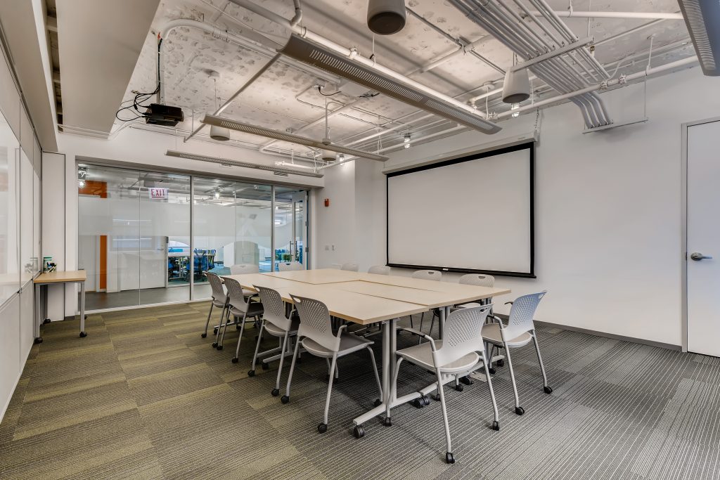 One of four available Conference Rooms Configured to fit 10-12 attendees with Presentation Screen and A/V